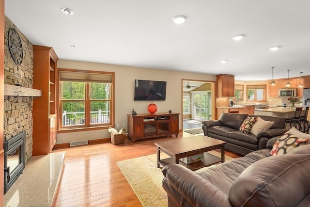 16 Blueberry Way, Webster, MA 01570 - living area with light wood-type flooring, a stone fireplace, and recessed lighting