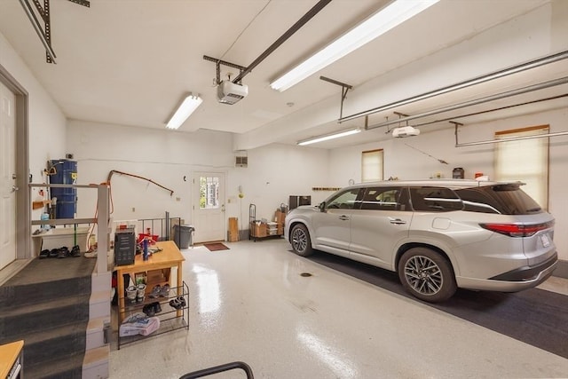 16 Blueberry Way, Webster, MA 01570 - garage featuring a garage door opener and secured water heater