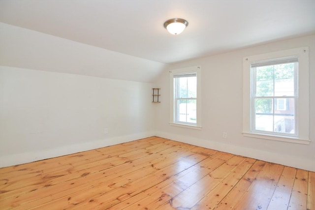 22 Chester Unit 22, Amesbury, MA 01913 - unfurnished room featuring wood-type flooring, lofted ceiling, plenty of natural light, and baseboards