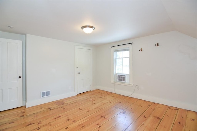 22 Chester Unit 22, Amesbury, MA 01913 - unfurnished room with hardwood / wood-style flooring, baseboards, cooling unit, and lofted ceiling