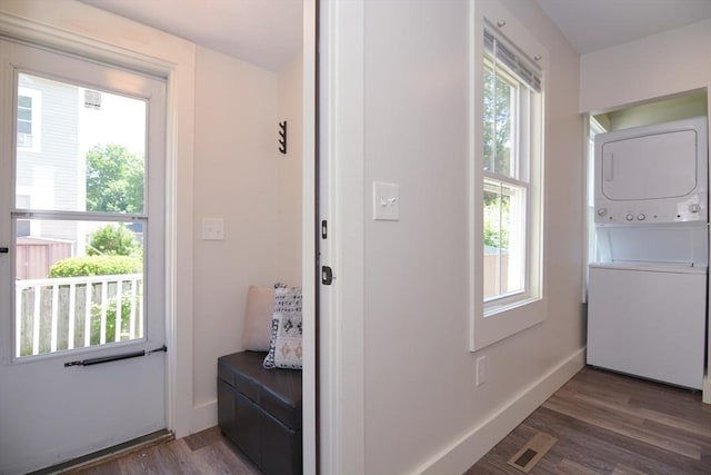 22 Chester Unit 22, Amesbury, MA 01913 - doorway to outside with stacked washer / dryer, wood finished floors, and baseboards