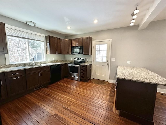 kitchen featuring black appliances, dark wood-style floors, and a sink