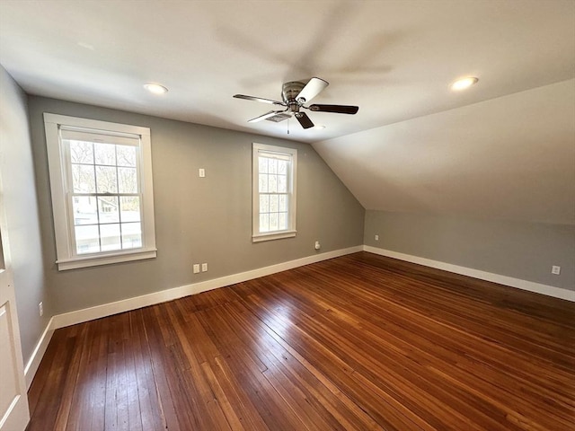 bonus room featuring lofted ceiling, ceiling fan, baseboards, and dark wood-type flooring