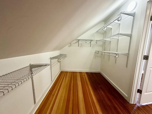 spacious closet featuring vaulted ceiling and wood finished floors