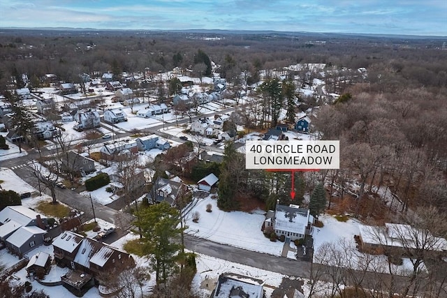 snowy aerial view with a residential view