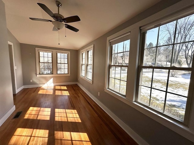 unfurnished sunroom featuring lofted ceiling and visible vents