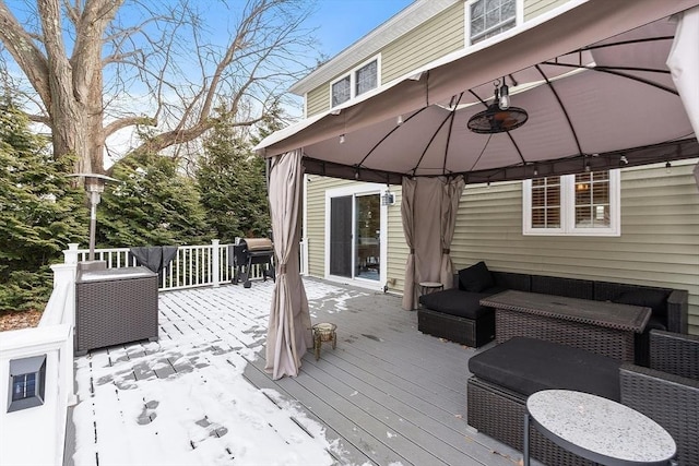 wooden deck with a gazebo, an outdoor living space, and area for grilling