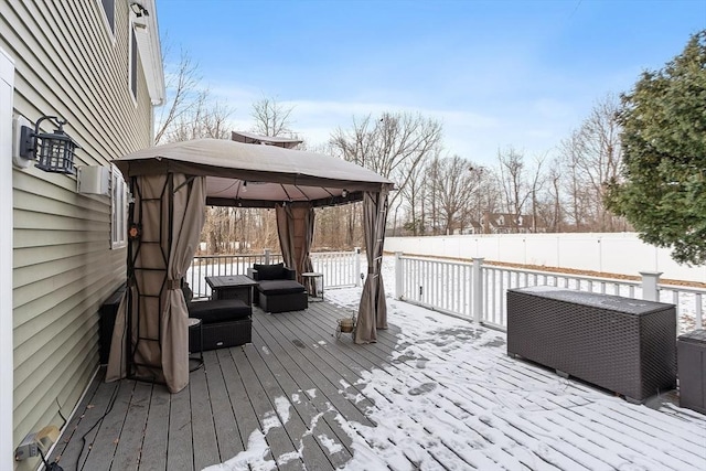 snow covered deck featuring a gazebo and an outdoor hangout area