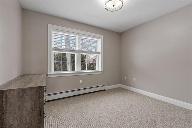 carpeted spare room with a baseboard radiator