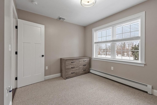 bedroom featuring a baseboard heating unit and light carpet