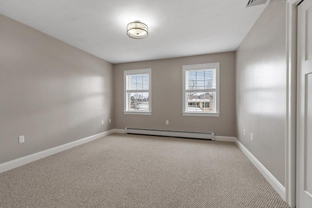 carpeted empty room with baseboard heating