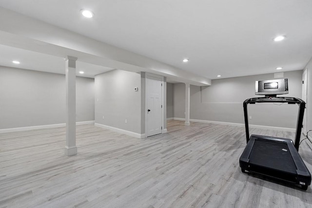 exercise room featuring light hardwood / wood-style floors