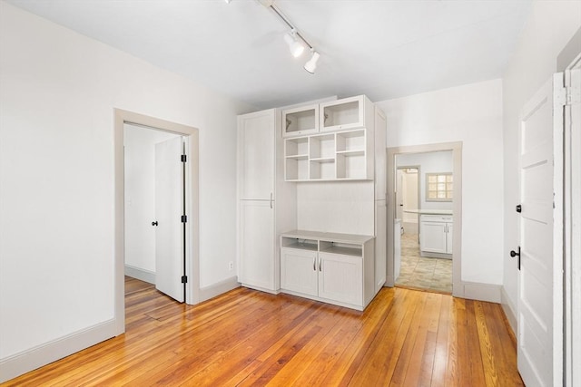 31 Hunting St, Cambridge, MA 02141 - unfurnished bedroom with light wood-type flooring and track lighting