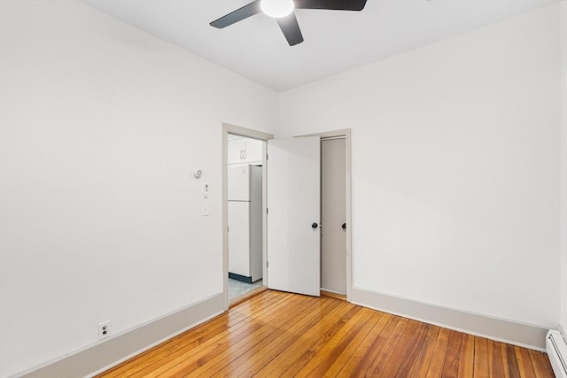 31 Hunting St, Cambridge, MA 02141 - unfurnished room featuring a baseboard heating unit, a ceiling fan, and light wood finished floors