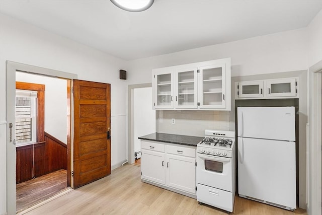 31 Hunting St, Cambridge, MA 02141 - kitchen featuring white appliances, white cabinets, decorative backsplash, glass insert cabinets, and light wood-style flooring