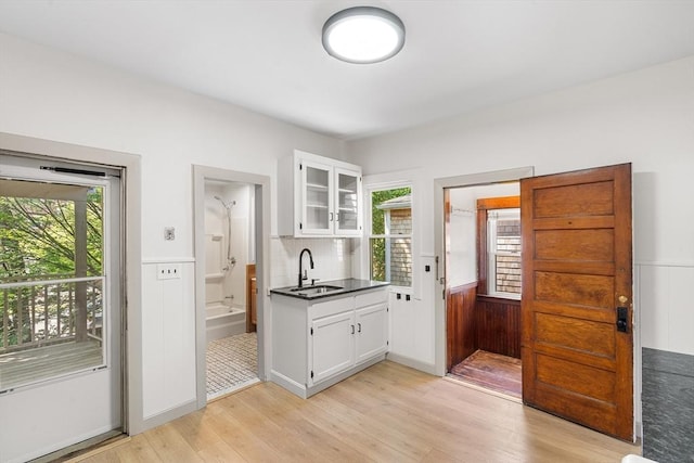 31 Hunting St, Cambridge, MA 02141 - entryway featuring healthy amount of natural light, light wood finished floors, and wainscoting
