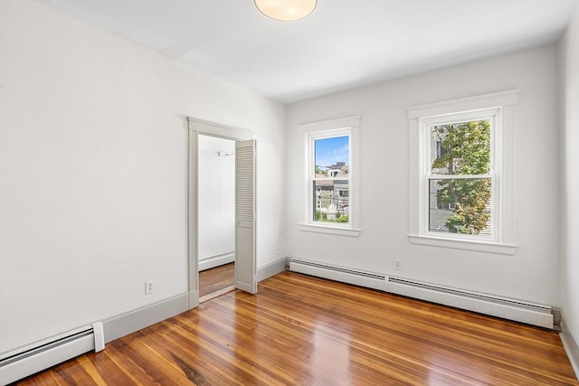 31 Hunting St, Cambridge, MA 02141 - unfurnished room featuring a baseboard radiator and wood finished floors