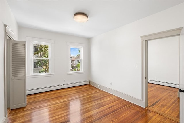31 Hunting St, Cambridge, MA 02141 - unfurnished bedroom with baseboard heating and light wood finished floors