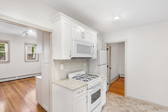31 Hunting St, Cambridge, MA 02141 - kitchen featuring white appliances, baseboard heating, backsplash, and white cabinetry