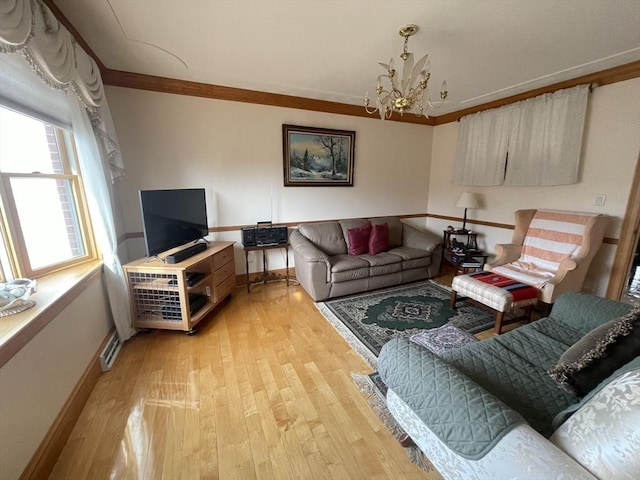26 Feeney Rd, Norwood, MA 02062 - living room featuring ornamental molding, a chandelier, light wood finished floors, and baseboards