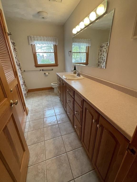 26 Feeney Rd, Norwood, MA 02062 - bathroom featuring vanity, tile patterned flooring, and toilet