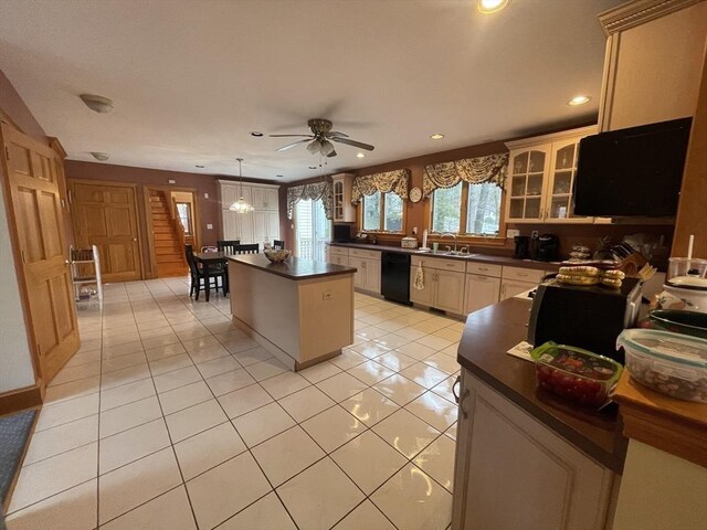 26 Feeney Rd, Norwood, MA 02062 - kitchen with black dishwasher, dark countertops, a kitchen island, a ceiling fan, and glass insert cabinets