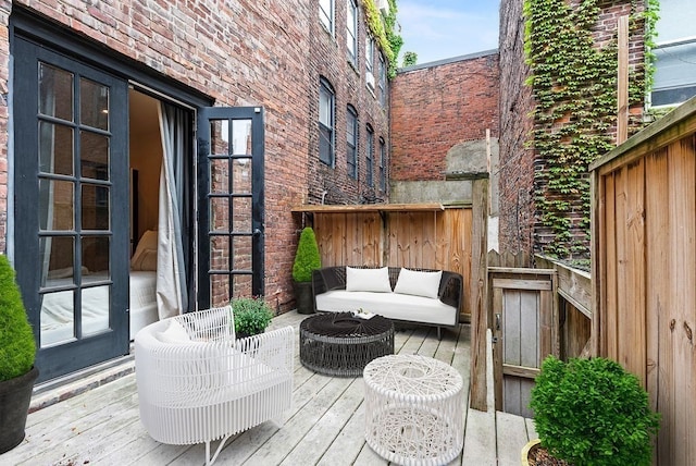 wooden terrace with an outdoor living space