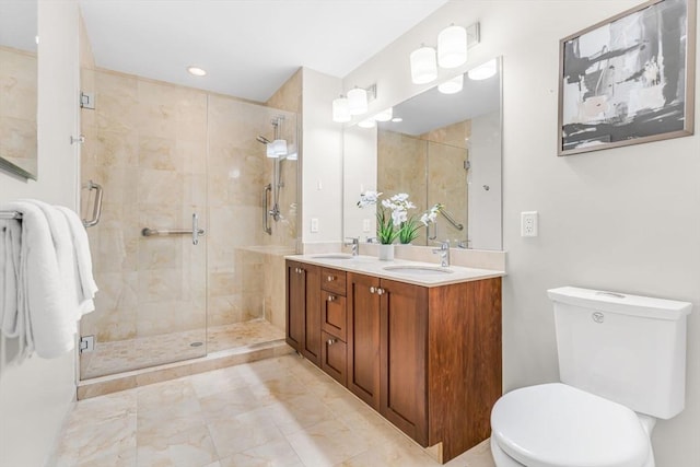 321 Hammond Pond Pkwy Unit 103, Brookline, MA 02467 - bathroom featuring toilet, double vanity, and a stall shower