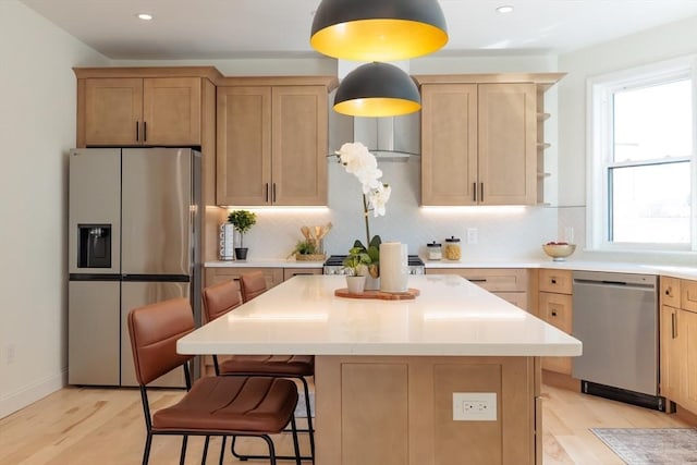 59 Dartmouth St Unit A, Somerville, MA 02145 - kitchen featuring stainless steel appliances, light brown cabinetry, tasteful backsplash, light wood-style floors, and light countertops