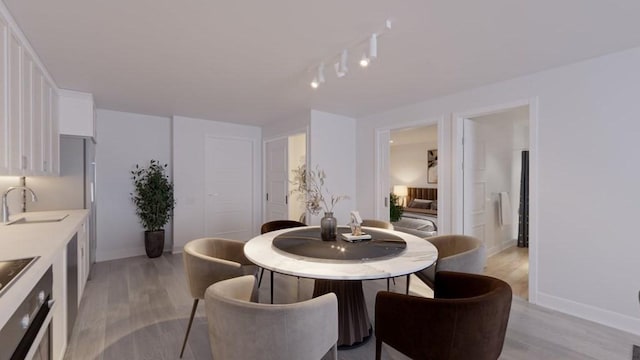 133 Salem Unit 418, Revere, MA 02151 - dining room featuring light wood-type flooring and rail lighting