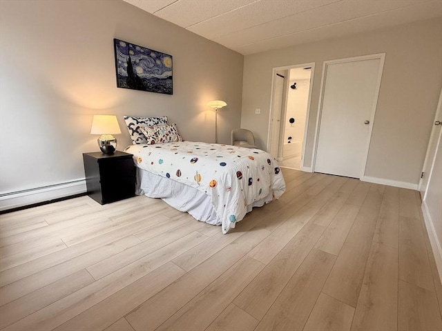 180 Green St Unit 415, Melrose, MA 02176 - bedroom featuring wood finished floors and baseboard heating