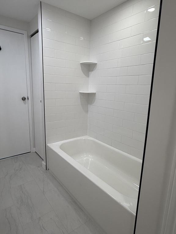 180 Green St Unit 415, Melrose, MA 02176 - bathroom featuring marble look tiles and bathing tub / shower combination
