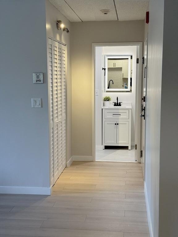 180 Green St Unit 415, Melrose, MA 02176 - hallway with baseboards and light wood-type flooring