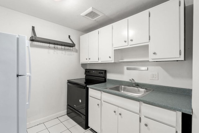 150 Main St Unit 12, Stoneham, MA 02180 - kitchen with black electric range oven, a sink, white cabinets, and light tile patterned flooring