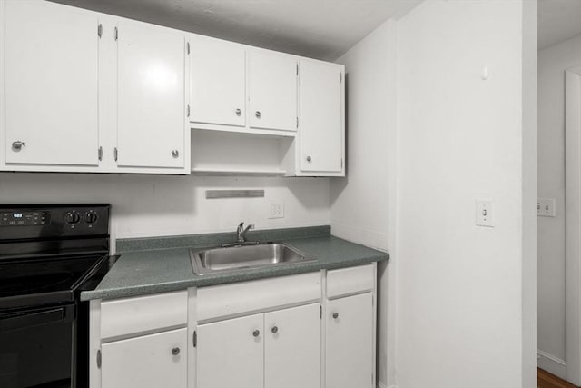 150 Main St Unit 12, Stoneham, MA 02180 - kitchen featuring black / electric stove, a sink, white cabinetry, and dark countertops
