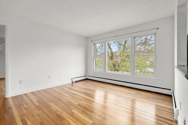 150 Main St Unit 12, Stoneham, MA 02180 - unfurnished room featuring light wood-style flooring, a baseboard radiator, and baseboards