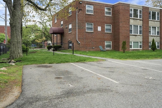 150 Main St Unit 12, Stoneham, MA 02180 - view of building exterior featuring uncovered parking and fence