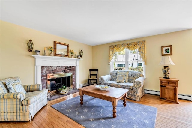 72 Rosemary Ln, Barnstable, MA 02632 - living area featuring light wood-style flooring, a baseboard heating unit, and a fireplace
