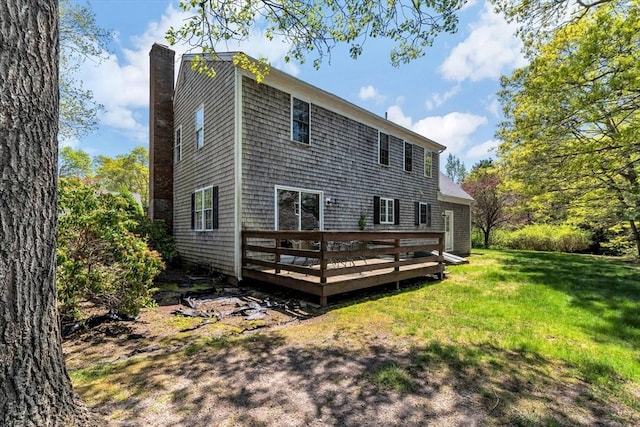 72 Rosemary Ln, Barnstable, MA 02632 - back of property with a chimney, a wooden deck, and a lawn