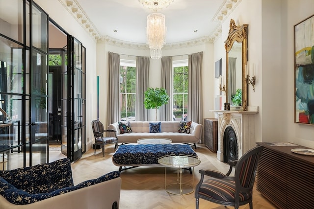 interior space with light parquet floors, ornamental molding, and an inviting chandelier