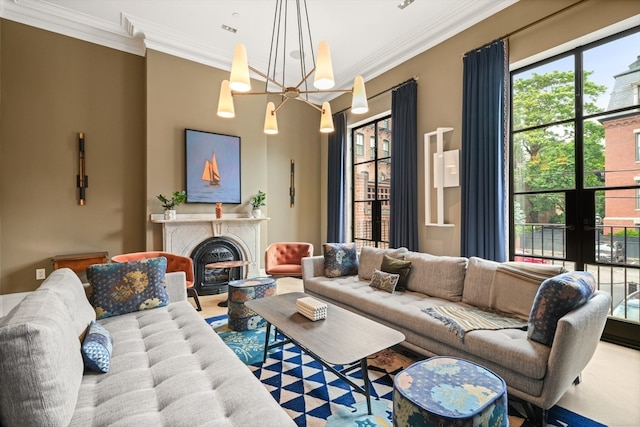 living room with an inviting chandelier and crown molding