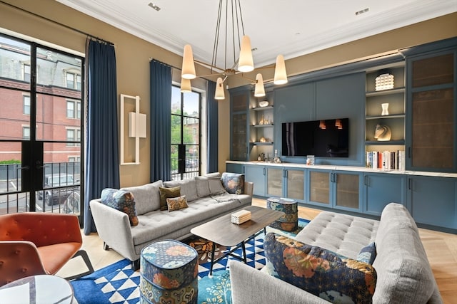 living room featuring ornamental molding, a chandelier, and built in features