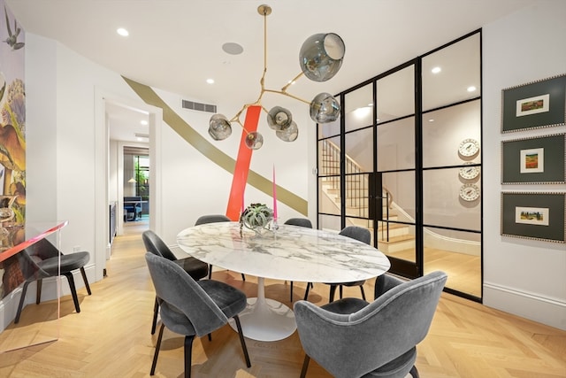 dining space featuring light parquet flooring