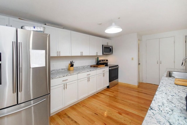 238 Brown Bear Xing Unit 238, Acton, MA 01720 - kitchen with stainless steel appliances, a sink, light wood-style flooring, and white cabinetry