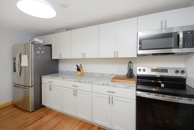 238 Brown Bear Xing Unit 238, Acton, MA 01720 - kitchen featuring stainless steel appliances, light wood-type flooring, white cabinetry, and light stone countertops