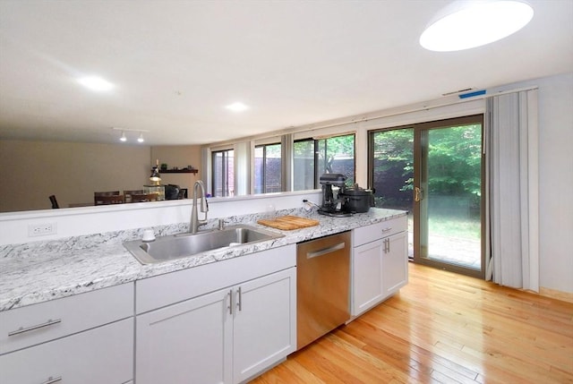 238 Brown Bear Xing Unit 238, Acton, MA 01720 - kitchen with dishwasher, a sink, light wood finished floors, white cabinets, and light stone countertops