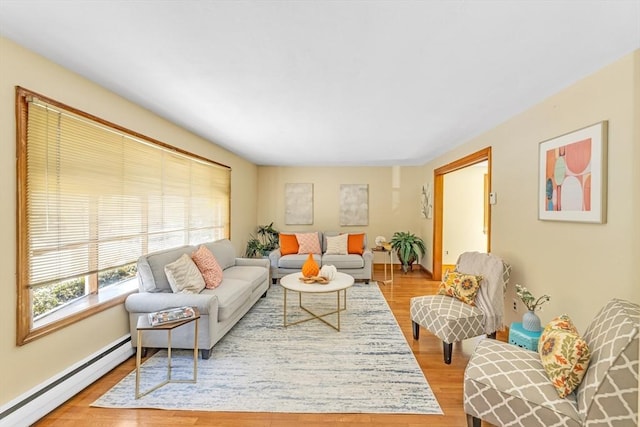 living room with a baseboard radiator and light wood-style floors