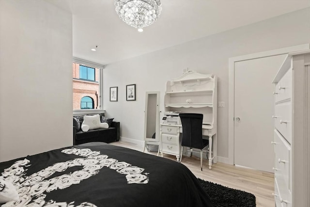 234 Causeway St Apt 709, Boston, MA 02114 - bedroom featuring baseboards, light wood-style flooring, and a notable chandelier