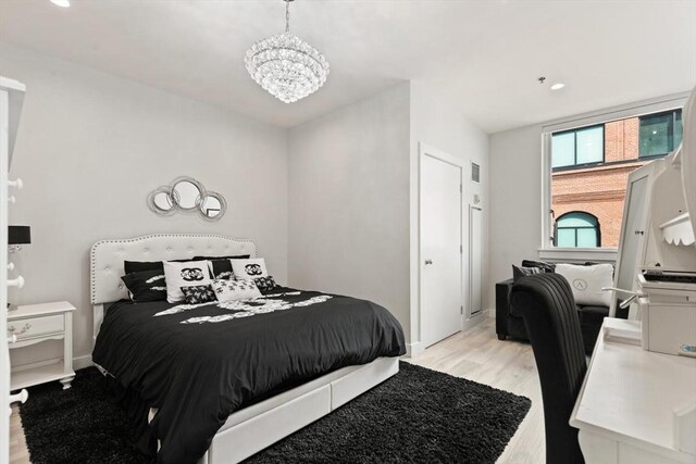 234 Causeway St Apt 709, Boston, MA 02114 - bedroom with light wood-type flooring, recessed lighting, baseboards, and a chandelier