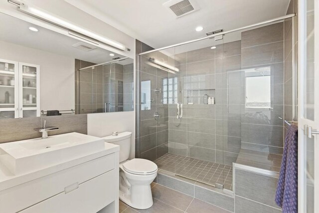 234 Causeway St Apt 709, Boston, MA 02114 - bathroom with tile patterned floors, a stall shower, toilet, and visible vents